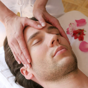 young man getting a facial massage