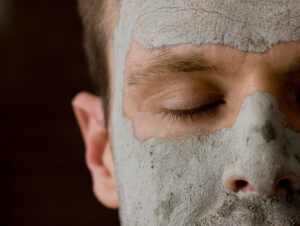 Man wearing a clay mud mask with his eyes closed. Represents male vanity or beauty spa.Please see some similar pictures from my portfolio: